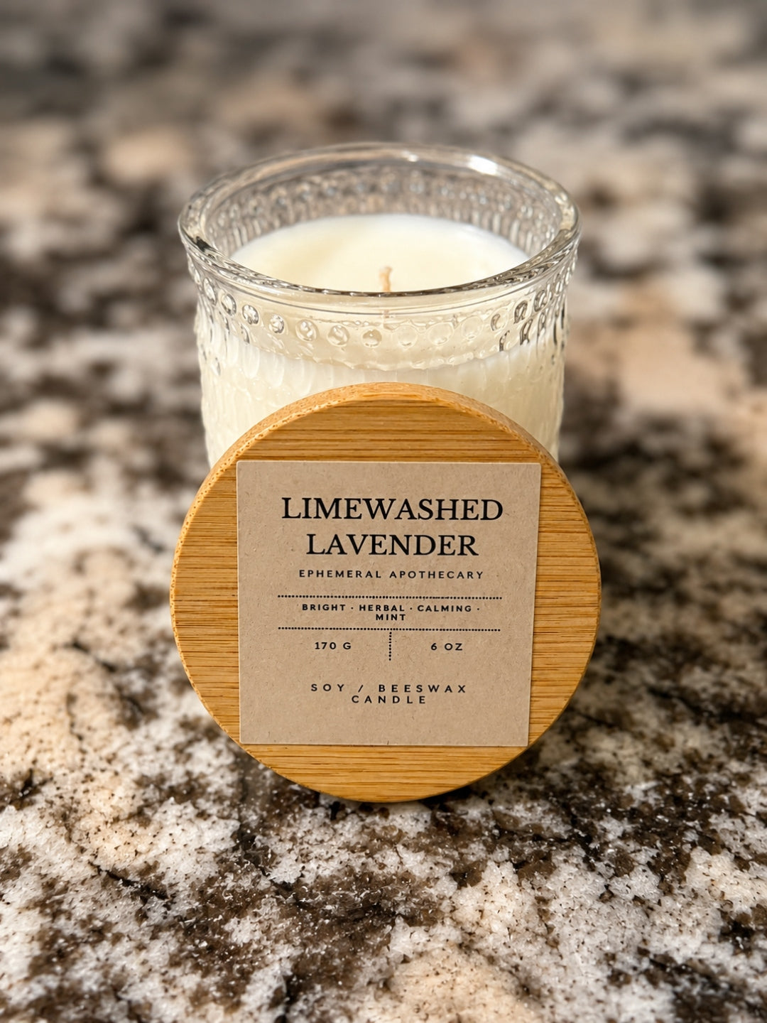 Limewashed Lavender candle jar with lid leaning against glass